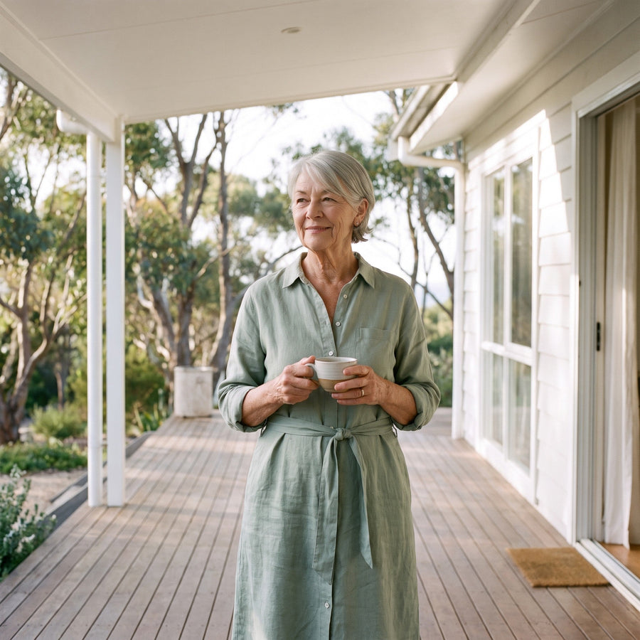 Woman in a sage green midi dress on the verandah