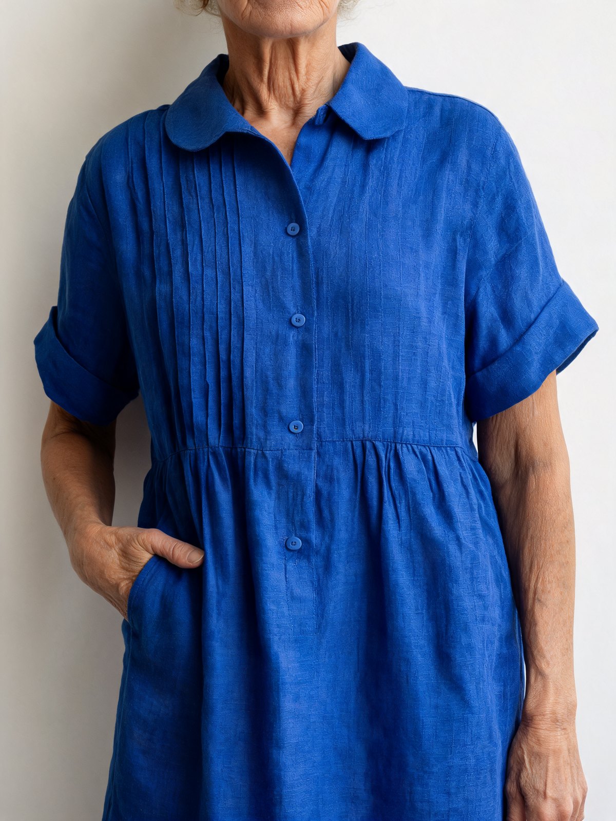 Blue, up close: collar, pin-tucks, buttons and pocket.