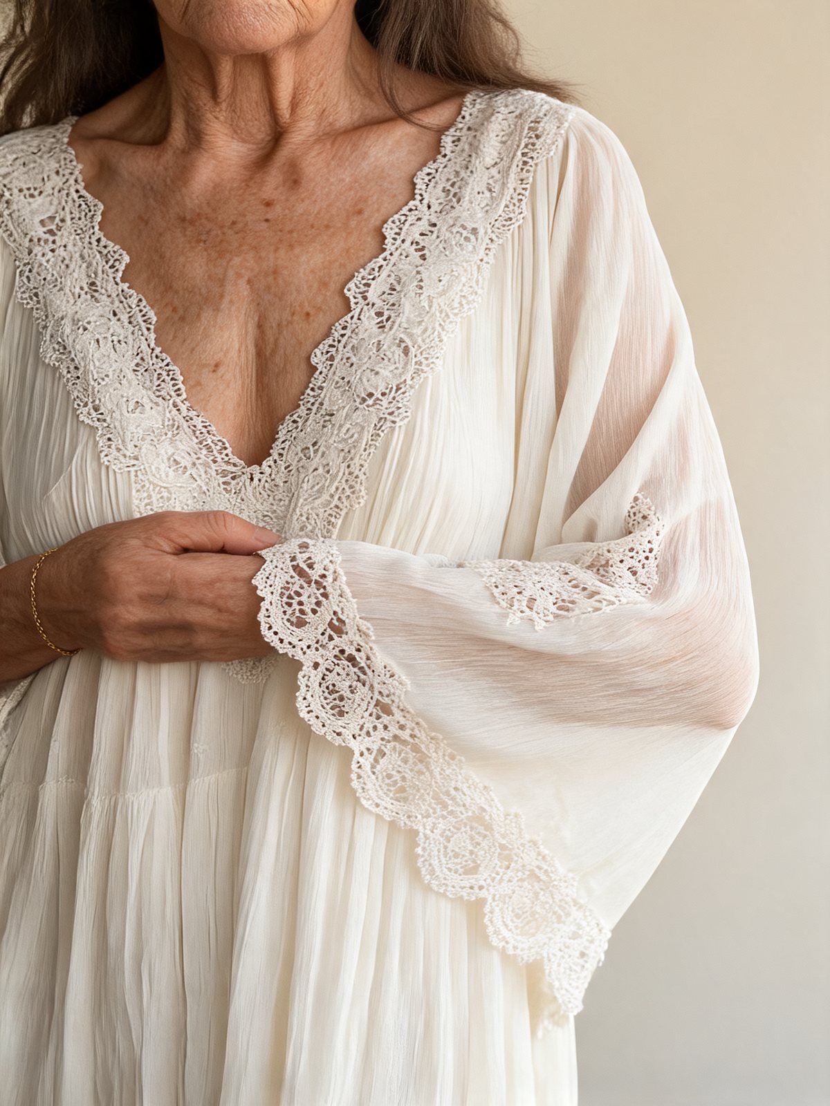 Close-up of the crochet lace neckline and sleeve of the Liora dress