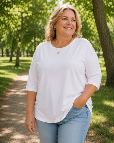 Woman in the Maeve tee in White with jeans in a park